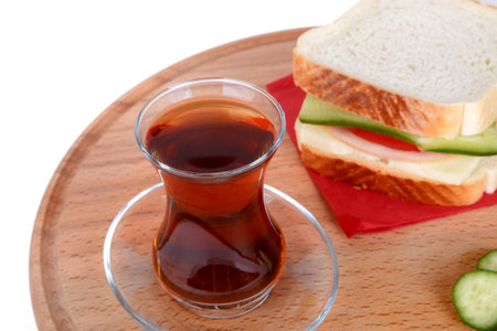 View of a sandwich with cheese, tomato and cucumber with black tea, isolated on white background.の写真素材