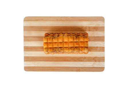 Close up detailed of top view of baton cacao cake, served on a cutting board, isolated on white background.の写真素材