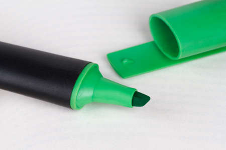 Close up detailed side view of green highlighter pen on paper.の写真素材