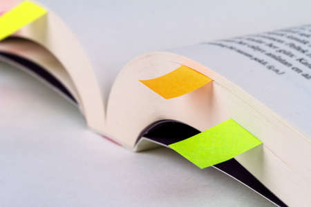 Close up detailed book notebook page view with sticky note paper on it.の写真素材