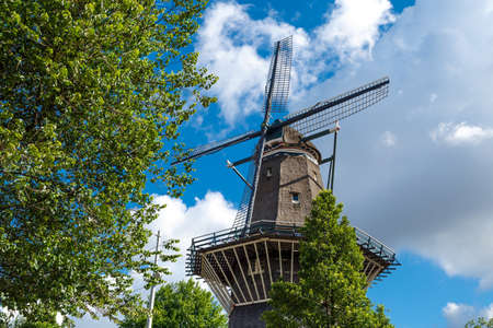 AMSTERDAM, NETHERLANDS - JULY 3, 2016 : View of famous historical De Gooyer Windmill on cloudy sky. Amsterdam is popular with windmills.のeditorial素材