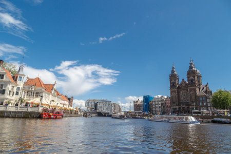 AMSTERDAM, NETHERLANDS - JULY 2, 2016 : View of small marina with sailboats in canals on bright sky. Amsterdam is popular with its canals.のeditorial素材