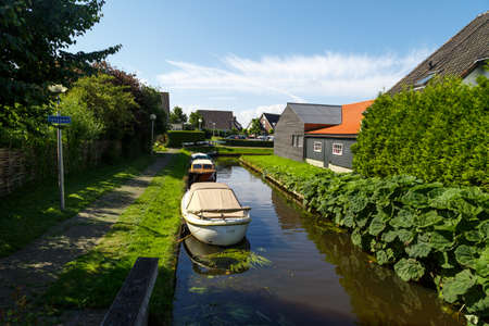 OVERIJSSEL, NETHERLANDS - JULY 4, 2016 : View of small sailboats in canals around trees in farm area. Giethoorn is very popular village.のeditorial素材