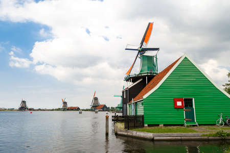 View of famous windmills in Zaanse Schans village in Zaandam on cloudy sky background.のeditorial素材