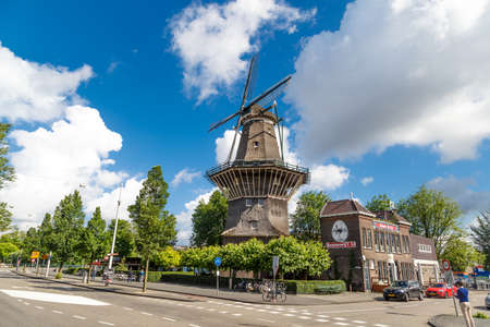 AMSTERDAM, NETHERLANDS - JULY 3, 2016 : View of famous historical De Gooyer Windmill on cloudy sky. Amsterdam is popular with windmills.のeditorial素材