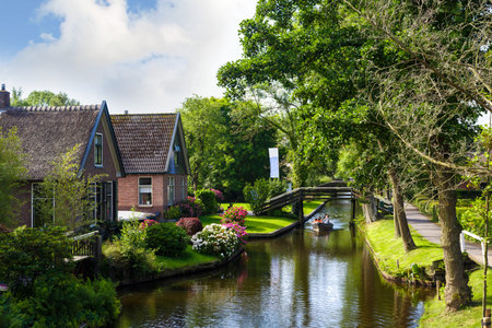 OVERIJSSEL, NETHERLANDS - JULY 4, 2016 : Landscape view of famous houses with thatched roofs around canals. Giethoorn is very popular village.のeditorial素材