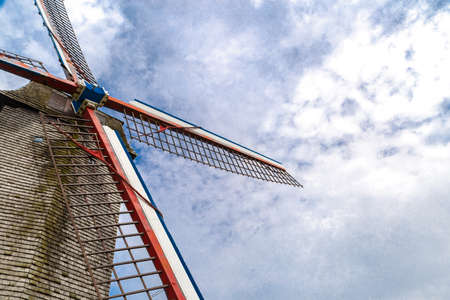 Close up detail view of historical windmill on small hill in nature in Brugge, Belgium.の写真素材