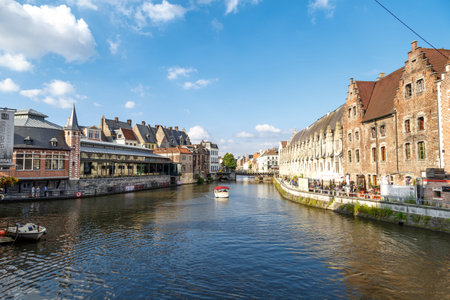 GENT, BELGIUM - JULY 6, 2016 : View of Graslei and Korenlei between medieval architecture buildings...