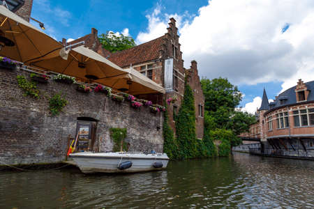 GENT, BELGIUM - JULY 6, 2016 : View of Graslei and Korenlei between medieval architecture buildings with tourist boats in Gent canal. Gent is popular place in Belgium.のeditorial素材