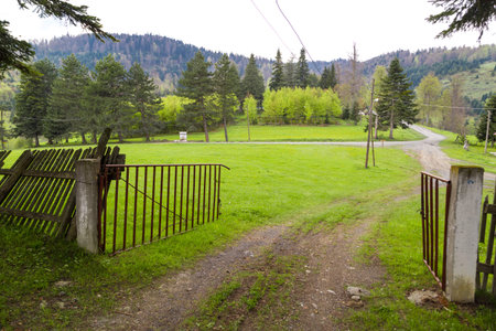 General view of Odayeri Plateau with mountain houses in meadow area on cloudy sky background.の写真素材