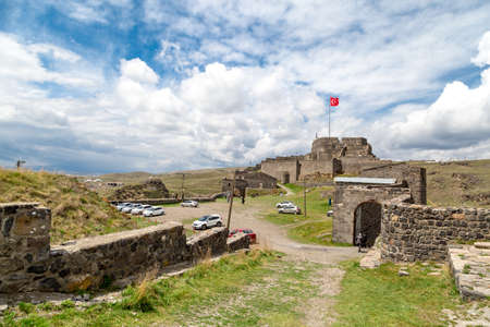 KARS, TURKEY - MAY 07, 2017 : General bottom view of historical famous Kars Castle on meadow hill, Kars, Eastern Anatolia Region Turkey on cloudy sky background.のeditorial素材