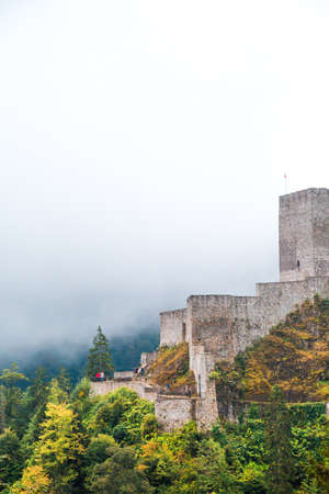 General view of Historical Zil Castle on the top of a hill with big stone walls between pine trees and foggy sky. Zil Castle was built in Byzantyne period.のeditorial素材