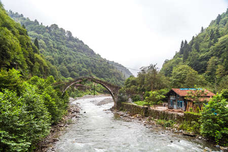 RIZE, TURKEY - AUGUST 15, 2016 : General landscape view of historical high stone bridges on Firtina river in Rize Camlihemsin area on foggy sky background.のeditorial素材