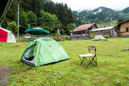 RIZE, TURKEY - AUGUST 17, 2016 : General landscape view of campground in meadow area on a mountain among big trees settled in Ayder Plateau, in Camlihemsin, Rize, Turkey.のeditorial素材