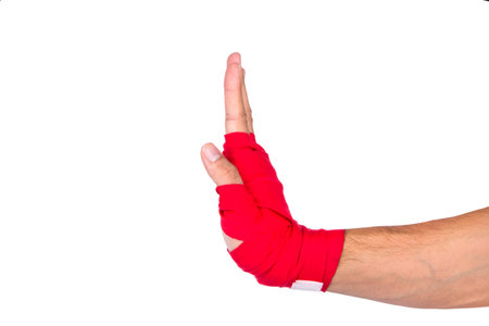 Close up detailed view of mixed martial arts athlete man hand with red boxing wraps, ready for fighting, exercising and strong, isolated on white background.の写真素材