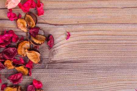 Close up detailed view of dried flowers and leaves around with romantic concept on wooden background.の写真素材