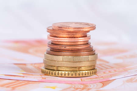 Stack of euro banknotes and coins, currency money in finance concept.の写真素材