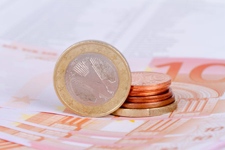 Stack of euro banknotes and coins, currency money in finance concept.