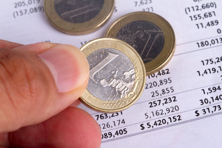 Finance concept, euro coins with graph chart management background.