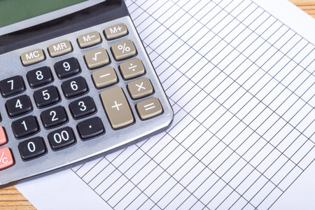 Finance and business concept, calculator on blank report paper.