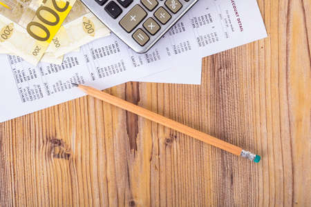 Finance and business concept, two hundred euro banknotes with pencil and calculator on earning report analytics.の写真素材