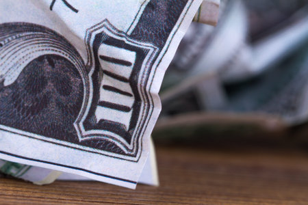 Dollar banknotes crumpled inside garbage basket, rubbish bin focused on consuming money in finance...
