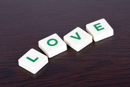 Word love with green and white letters on wooden background.の写真素材