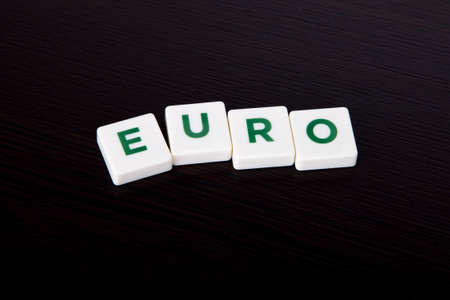 Euro with letters and on wooden background.の写真素材