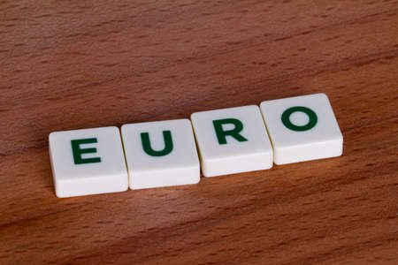 Euro with letters and on wooden background.の写真素材