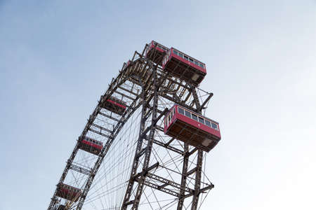 View of famous historic red and the oldest ferris wheel of Europe, cabin up in the air on Prater Park.のeditorial素材