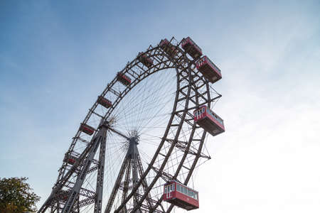 View of famous historic red and the oldest ferris wheel of Europe, cabin up in the air on Prater Park.のeditorial素材