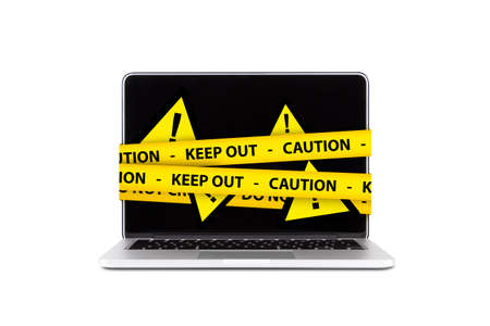 Yellow triangle warning sign with exclamation mark and caution tapes on computer, isolated on white background.の写真素材