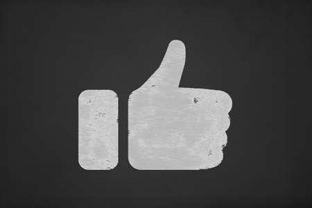 Illustrative white thumb up like sign, icon on black chalk board.の写真素材