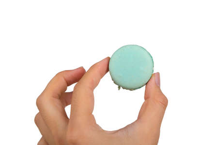 Detailed view of colorful tasty and yummy macarons on hand, isolated on white background.の写真素材