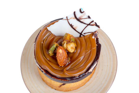 Yummy tasty chocolate cake with cream and nuts, isolated on white background.の写真素材