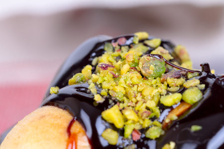 Yummy tasty cake with cream, nuts and caramel sauce, served with almonds.の写真素材