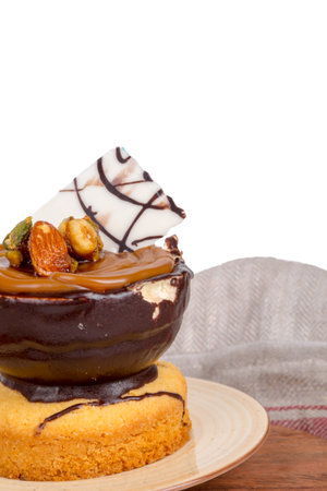 Yummy tasty chocolate cake with cream and nuts, isolated on white background.