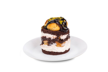 Yummy tasty chocolate cake with cream and nuts, isolated on white background.