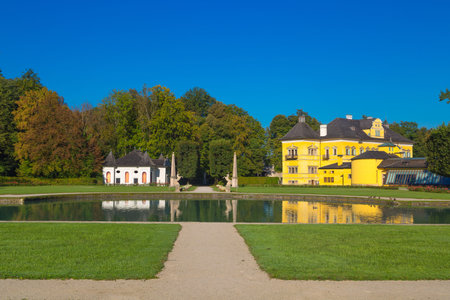 Landscape view of garden park of Hellburnn Palace with an artificial pond, an early baroque villa...