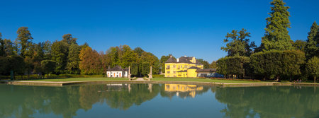 Landscape view of garden park of Hellburnn Palace with an artificial pond, an early baroque villa...