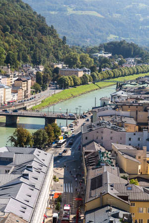 SALZBURG, AUSTRIA - SEPTEMBER 13, 2016 : Cityscape view of historic Salzburg city in Austria, old town city center and Salzach river on blue sky background.のeditorial素材