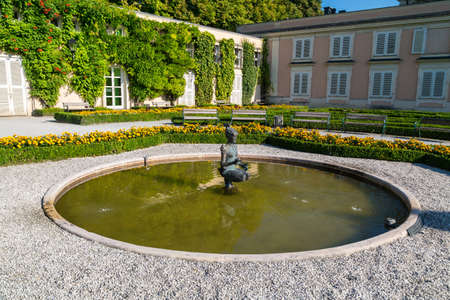 SALZBURG, AUSTRIA - SEPTEMBER 13, 2016 : Colorful beautiful garden view of Mirabell Palace with decorative pools and sculptures. Mirabell Palace is one of the most popular tourist attractions in Salzburg.のeditorial素材