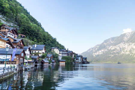 HALLSTATT, AUSTRIA - SEPTEMBER 14, 2016 : Landscape view of Hallstatt village with fancy mountain houses by Hallstatt lake among high Alp Mountains.のeditorial素材