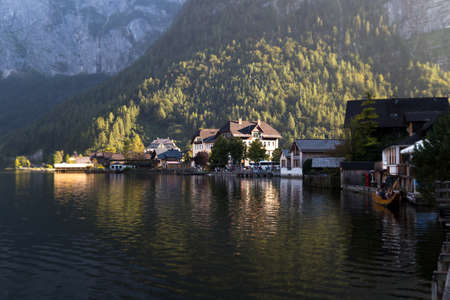 HALLSTATT, AUSTRIA - SEPTEMBER 14, 2016 : Landscape view of Hallstatt village with fancy mountain houses by Hallstatt lake among high Alp Mountains.のeditorial素材