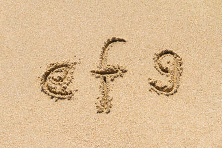 Set of efg letters of alphabet written on sand with lower case.の写真素材