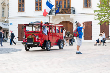 BRATISLAVA, SLOVAKIA - SEPTEMBER 17, 2016 : Historical sqaure of Bratislava and tourists travel by red bus. City is touristic, political and cultural center of Slovakia.のeditorial素材