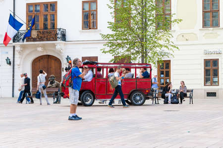 BRATISLAVA, SLOVAKIA - SEPTEMBER 17, 2016 : Historical sqaure of Bratislava and tourists travel by red bus. City is touristic, political and cultural center of Slovakia.のeditorial素材
