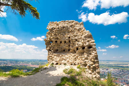 Cityscape view from historical Kutahya Castle with brick stone walls and bastions on cloudy blue sky background in Turkey.の写真素材