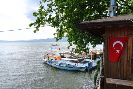 BURSA, TURKEY - APRIL 21, 2018 : Beautiful Uluabat lake view with boats and trees in Golyazi (Apolyont) in Bursa city of Turkey.のeditorial素材