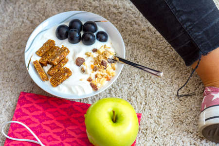 Close up view of casual style woman legs with healthy eating concept with apple, yogurt and some fruits.の写真素材